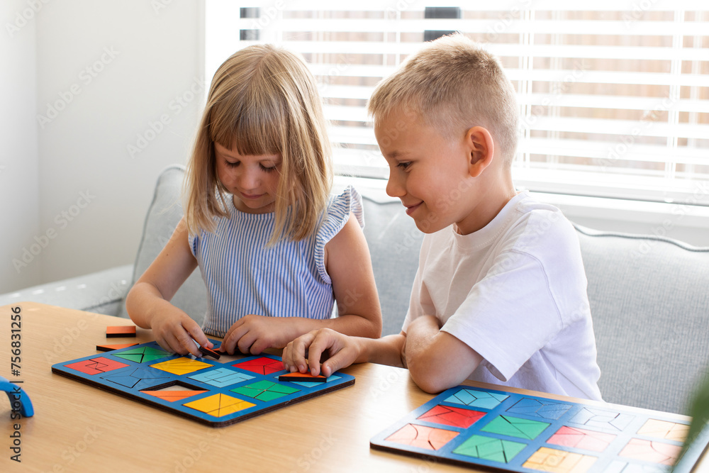 Brother and sister are playing educational wooden logic games. The concept of child development 