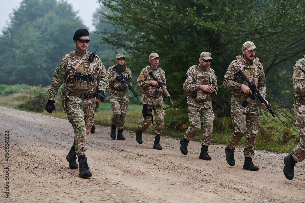 Fototapeta premium An elite military unit, led by a major, confidently parades through dense forest, showcasing precision, discipline, and readiness for high-risk operations
