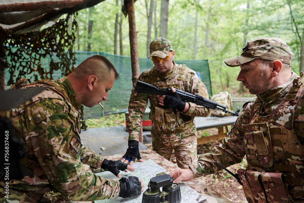 A highly trained military unit strategizes and organizes a tactical mission while studying a military map during a briefing session