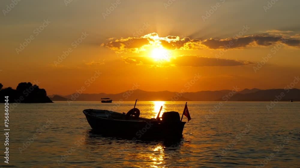 Swimmer by the old boat in lake. A view of swimmer silhouette relax by the boat in river under warm sunset sun rays in summer. Swimmer by the old boat in lake. A view of swimmer silhouette relax by the boat in river under warm sunset sun rays in summer.