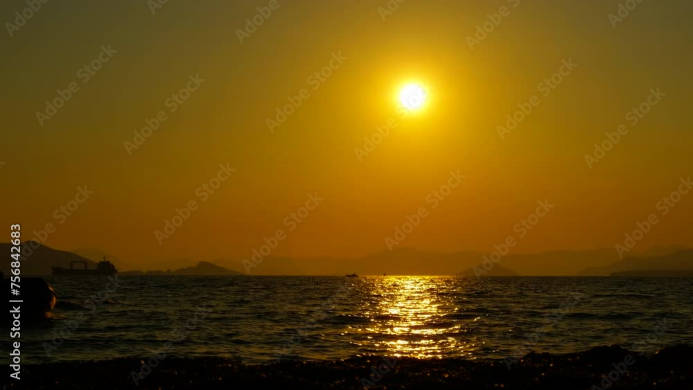 Ship silhouette floating during evening time. A view of ship with no sails silhouette floating by the lonely bay during colorful evening time. Ship silhouette floating during evening time. A view of ship with no sails silhouette floating by the lonely bay during colorful evening time.