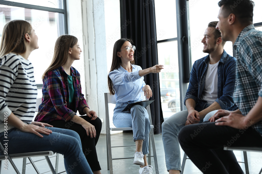 Psychotherapist working with patients in group therapy session indoors Psychotherapist working with patients in group therapy session indoors