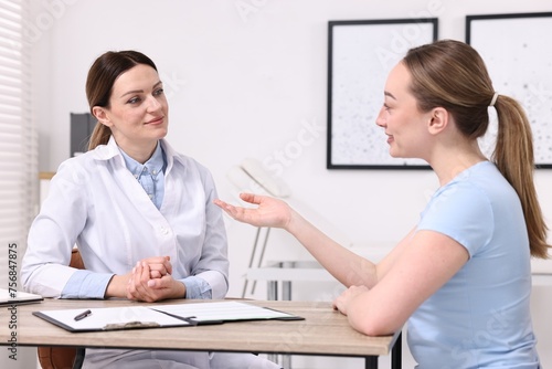 Mammologist consulting woman during appointment in hospital
