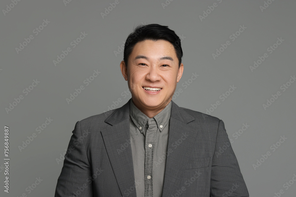 Portrait of happy businessman on grey background Portrait of happy businessman on grey background