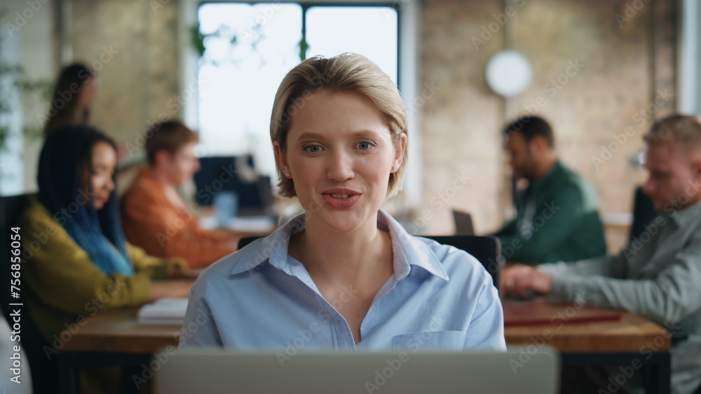 Manager greeting video meeting sitting office coworking space with team close up Manager greeting video meeting sitting office coworking space with team close up
