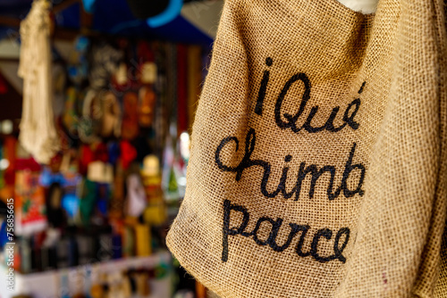 Burlap bag with the inscription in Spanish "Wonderful, friend!" hanging in a market