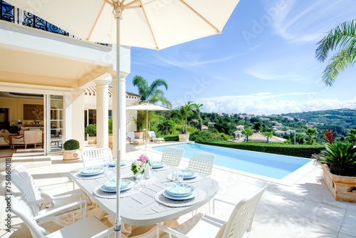 An elegant outdoor dining setup by a pool with a view of rolling hills and clear skies.