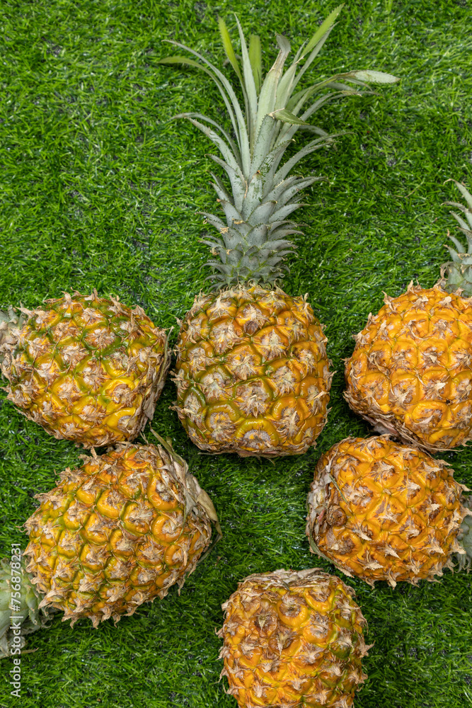 Fresh, delicious pineapple on the grass Fresh, delicious pineapple on the grass