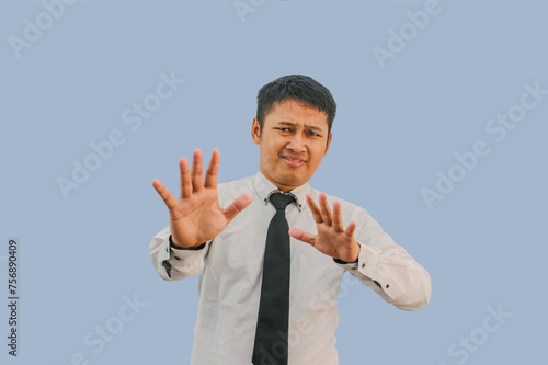 Adult asian man screaming ekspression scared while his hands doing stop gesture photo