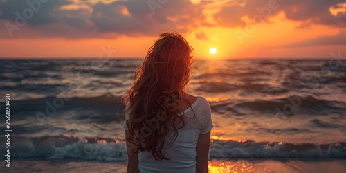 Woman embracing the sunset peaceful and content by the sea. Concept Nature, Sunset, Embrace, Peaceful, Content © Ян Заболотний
