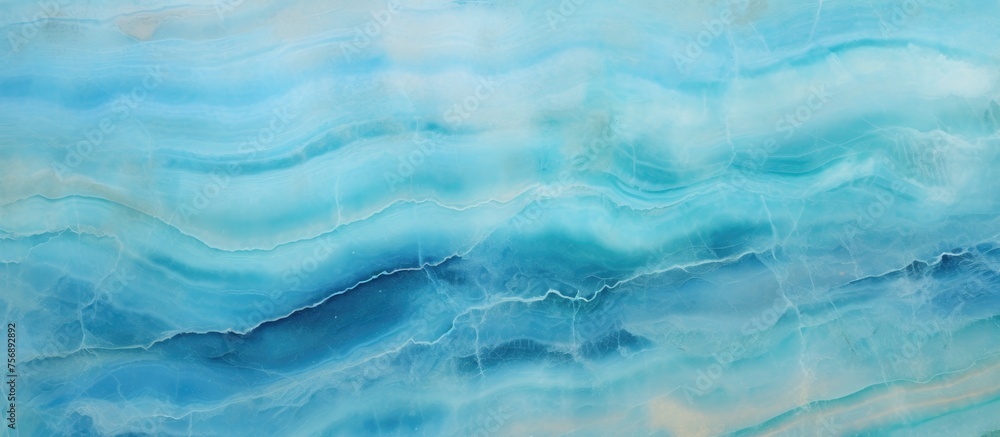 A detailed closeup of an electric blue marble texture resembling a fluid water pattern, reminiscent of wind waves or cumulus clouds in the ocean