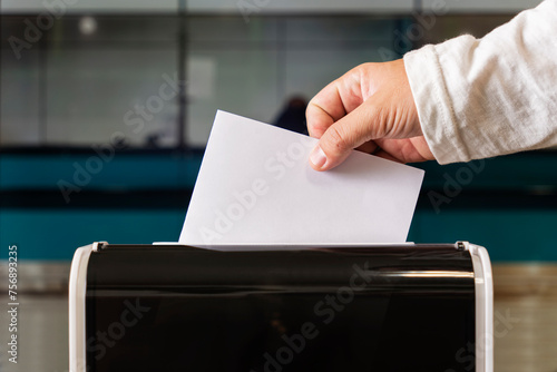 person casts her ballot during voting for parliamentary elections at a polling station photo