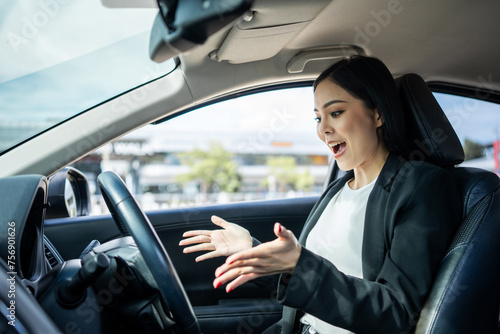 Young beautiful asian business women getting new car Very surprised happy and excited. Smiling female driving vehicle on the road on a bright day with sun light. Business woman buying driving new car © Chanakon