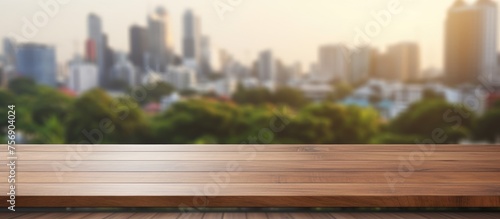 A wooden table featuring a city skyline with skyscrapers  buildings  and condominiums in the background. The urban design contrasts with the natural landscape of grass and horizon