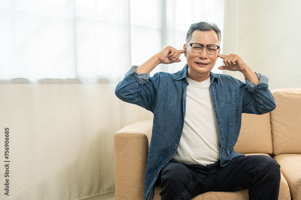 Handsome asian mature old man stressed and frustrated covering his ears with his hands due to loud noise Neighbors disturb around the home. Annoyed noise sound pollution. Asian old man blocking ears Handsome asian mature old man stressed and frustrated covering his ears with his hands due to loud noise Neighbors disturb around the home. Annoyed noise sound pollution. Asian old man blocking ears