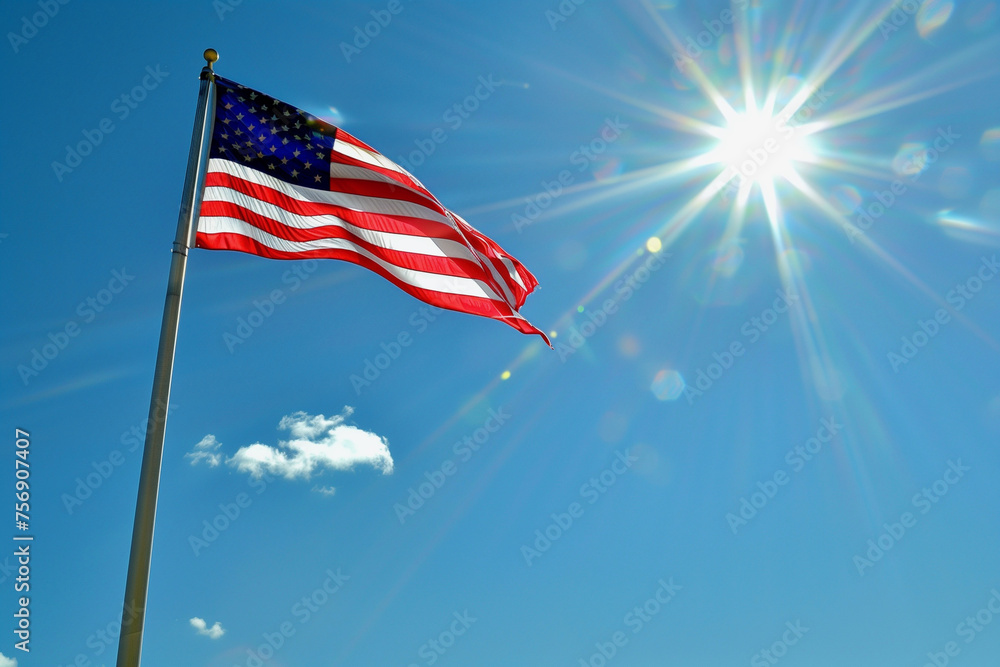 A red, white, and blue American flag is flying in the sky. The sun is ...