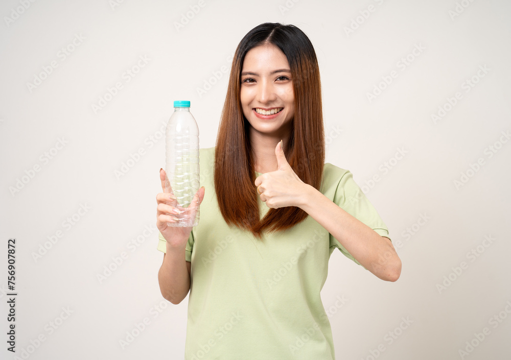 Young asian beautiful woman holding plastic of bottle assume Garbage sorting before throwing them into the bin. Activist environmental woman in green shirt with recycle and sustainability concept. Young asian beautiful woman holding plastic of bottle assume Garbage sorting before throwing them into the bin. Activist environmental woman in green shirt with recycle and sustainability concept.