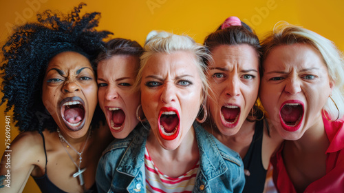 Group of furious angry women yelling looking at the camera photo