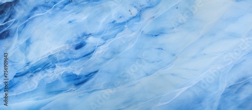 A close up of a blue and white marble texture resembling a cloudy sky with cumulus clouds. The pattern resembles a freezing meteorological phenomenon in a natural landscape