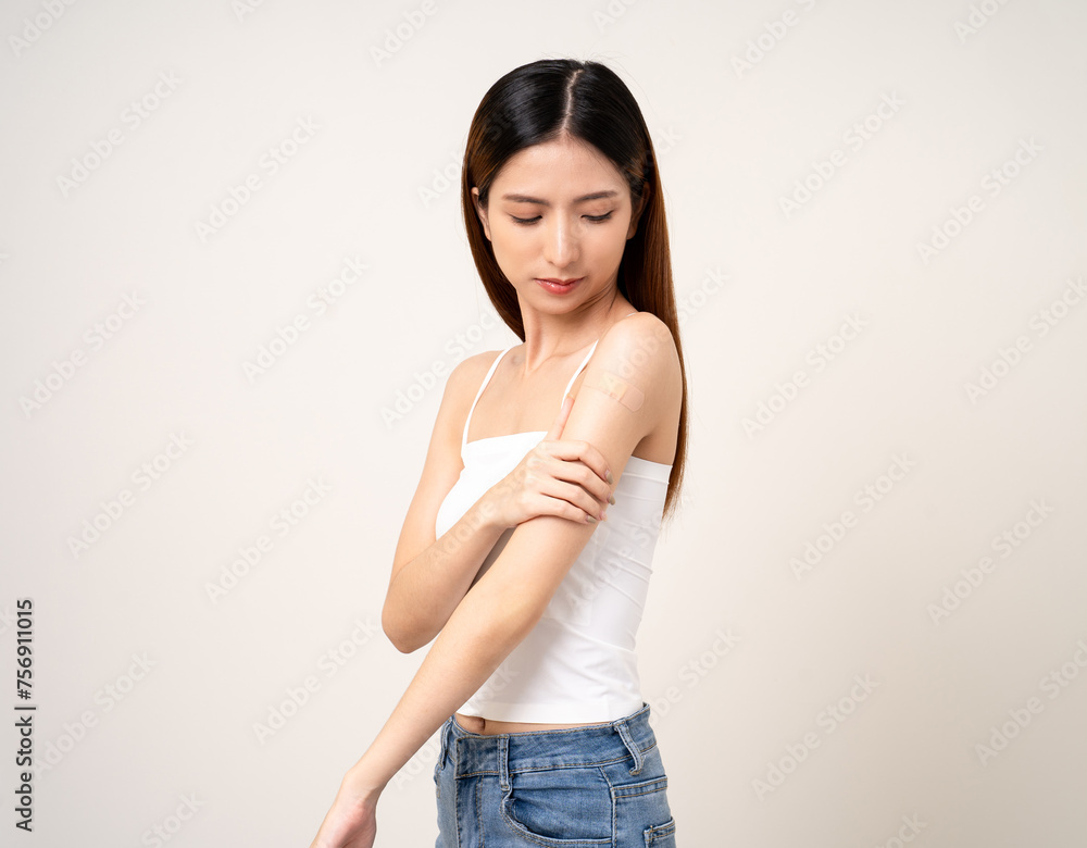 Vaccination. Young beautiful asian woman getting a vaccine protection the coronavirus. Smiling happy female showing arm with bandage after receiving vaccination. On isolated white background. Vaccination. Young beautiful asian woman getting a vaccine protection the coronavirus. Smiling happy female showing arm with bandage after receiving vaccination. On isolated white background.