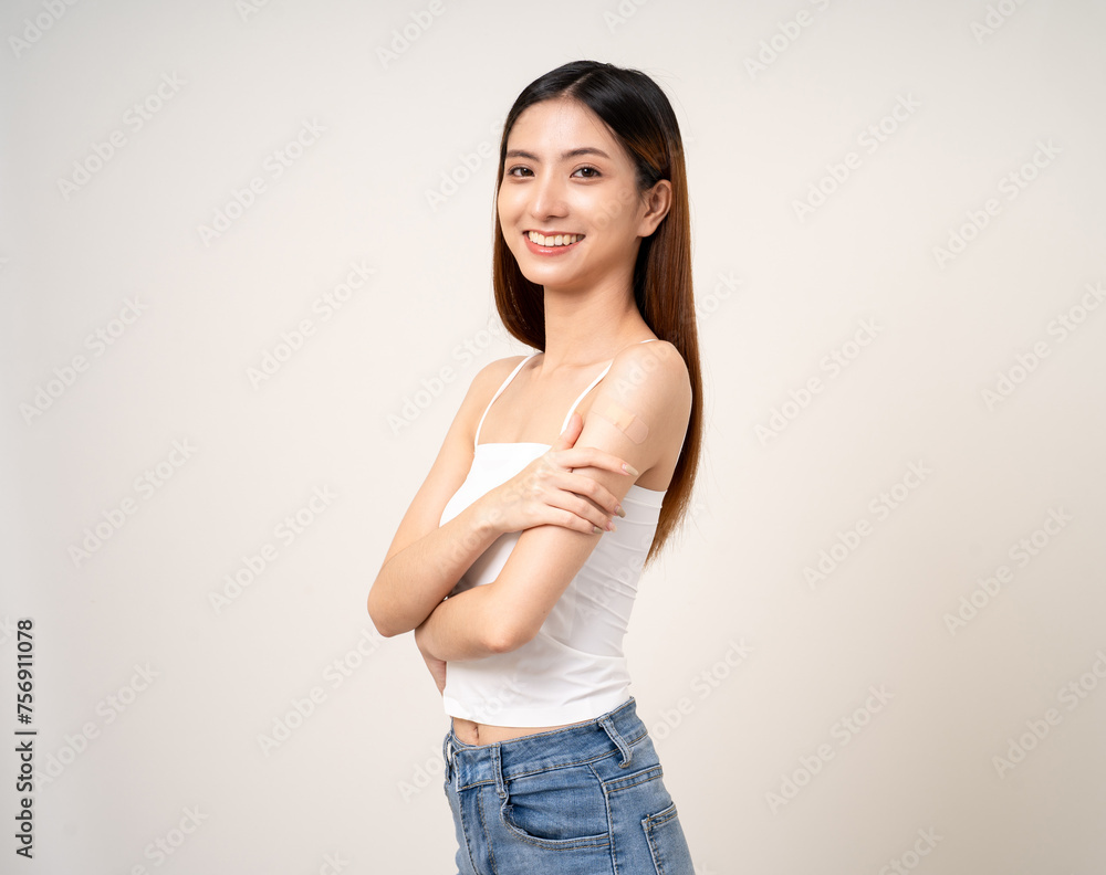 Vaccination. Young beautiful asian woman getting a vaccine protection the coronavirus. Smiling happy female showing arm with bandage after receiving vaccination. On isolated white background. Vaccination. Young beautiful asian woman getting a vaccine protection the coronavirus. Smiling happy female showing arm with bandage after receiving vaccination. On isolated white background.