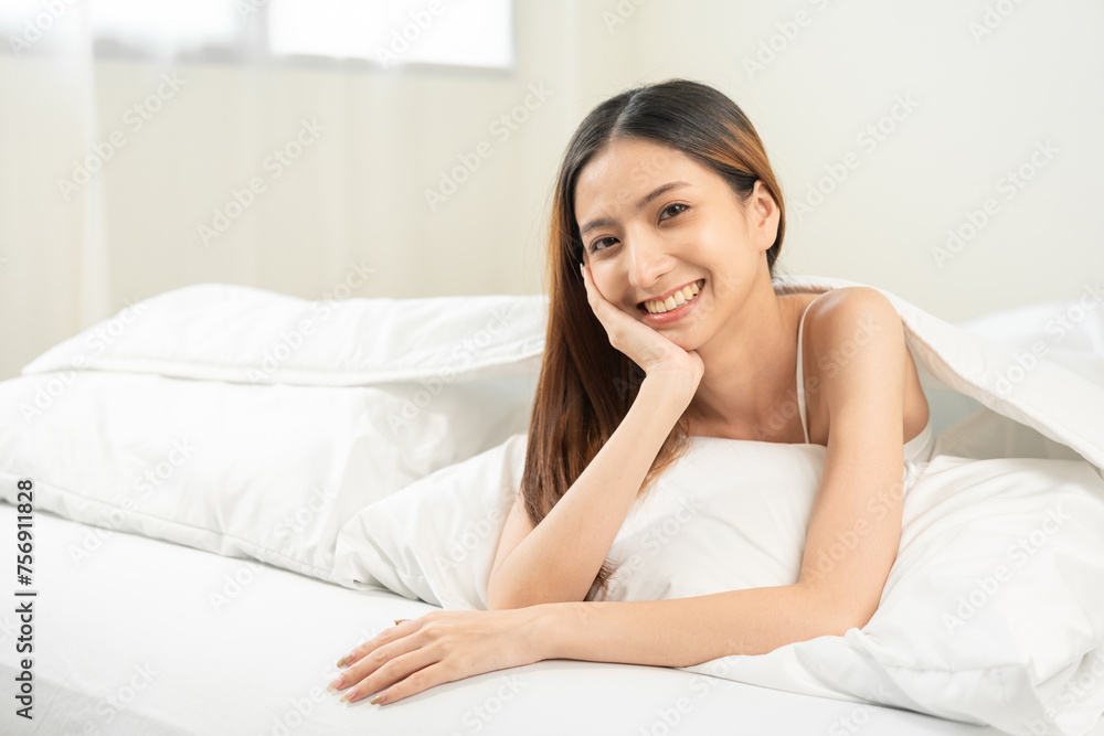 Young woman wake up before lying asleep enjoying healthy in the morning. Beautiful asian woman sleeping well in comfortable cozy fresh bed on soft pillow white linen. Young woman wake up before lying asleep enjoying healthy in the morning. Beautiful asian woman sleeping well in comfortable cozy fresh bed on soft pillow white linen.