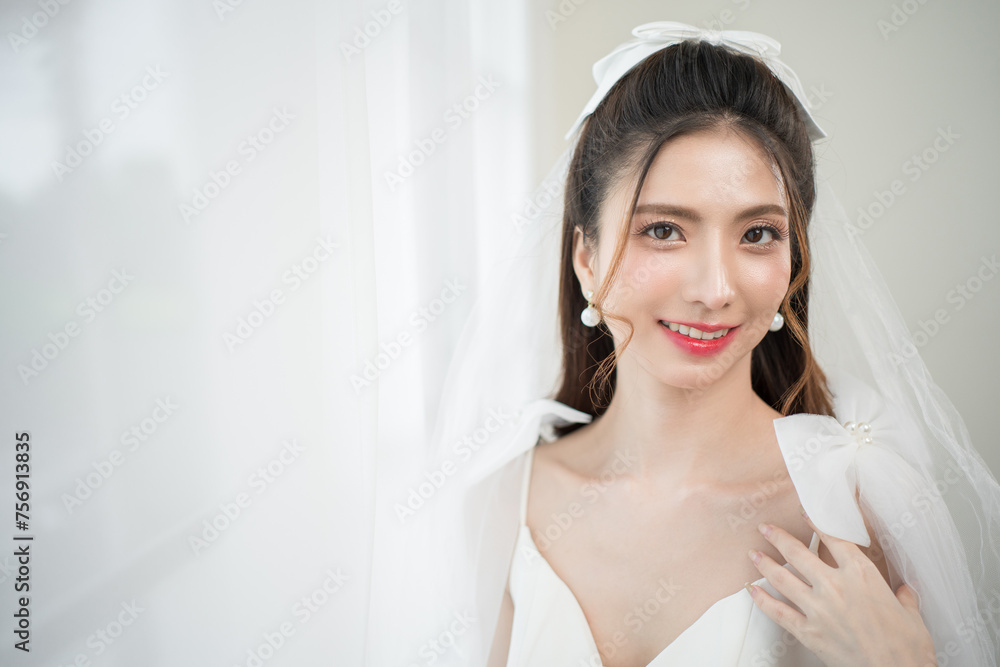 Beautiful asian bride with fashion wedding hairstyle and makeup. Portrait of young gorgeous bride wedding studio shot in white room. Beautiful asian bride with fashion wedding hairstyle and makeup. Portrait of young gorgeous bride wedding studio shot in white room.
