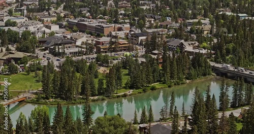 Banff AB Canada Aerial v39 zoomed drone flyover away from town center capturing picturesque townscape by the pristine Bow river surrounded by mountain ranges - Shot with Mavic 3 Pro Cine - July 2023 photo