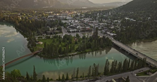 Banff AB Canada Aerial v20 birds eye view flyover Bow river across the town along the Banff avenue capturing quaint townscape and forested valleys at sunrise - Shot with Mavic 3 Pro Cine - July 2023 photo