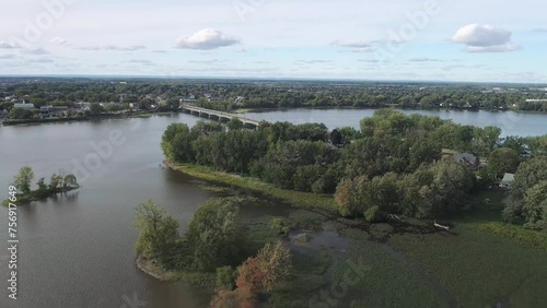 High-altitude, gently receding drone view of the Arthur-Sauvé Bridge between Laval and St-Eustache in autumn.