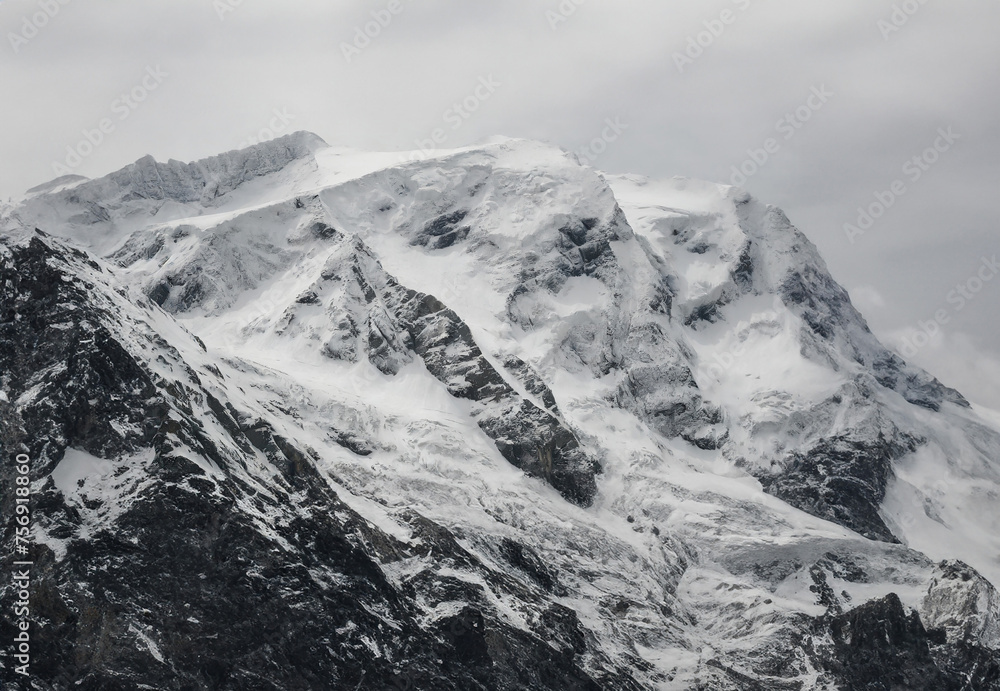 Obraz premium Snowy mountains with clouds in Cordillera Blanca, Peru