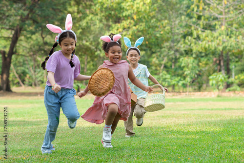Group of children happily runs around pick up Easter eggs in the park, Easter egg hunt concept, selective focus photo
