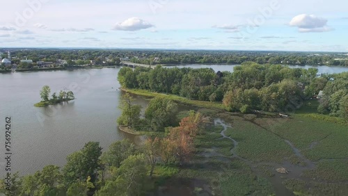 High-altitude, gently descending drone view of the Arthur-Sauvé Bridge between Laval and St-Eustache in autumn.