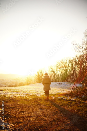 person walking in the woods, sunset over the city view in Freiburg im Breisgau, Germany