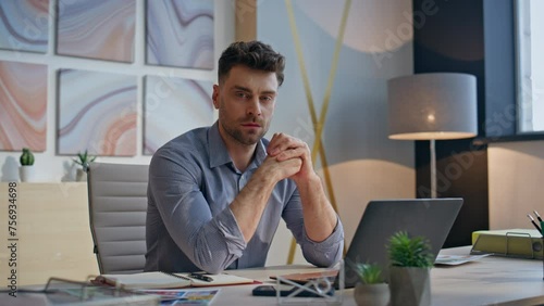 Pensive boss contemplating office closeup. Tired man finish work looking camera
