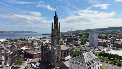 Greenock, Scotland UK. Aerial View of Birds Flying Above Former St George's North Church and Cityscape on Sunny Day photo