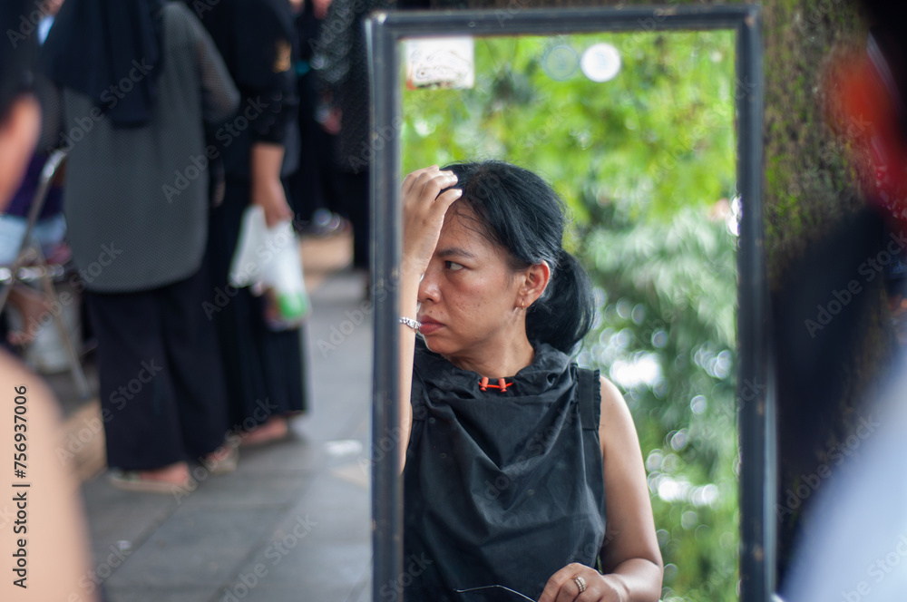 reflection in the mirror of a woman in a public place