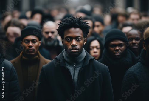 A man stands before a group of people, detailed crowd scenes showing serene faces. © Duka Mer