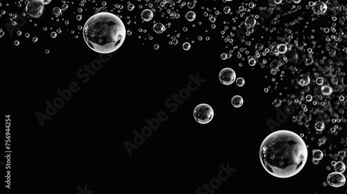 Air bubbles suspended in water create an abstract background, with oxygen bubbles in the sea depicted in black and white tones.