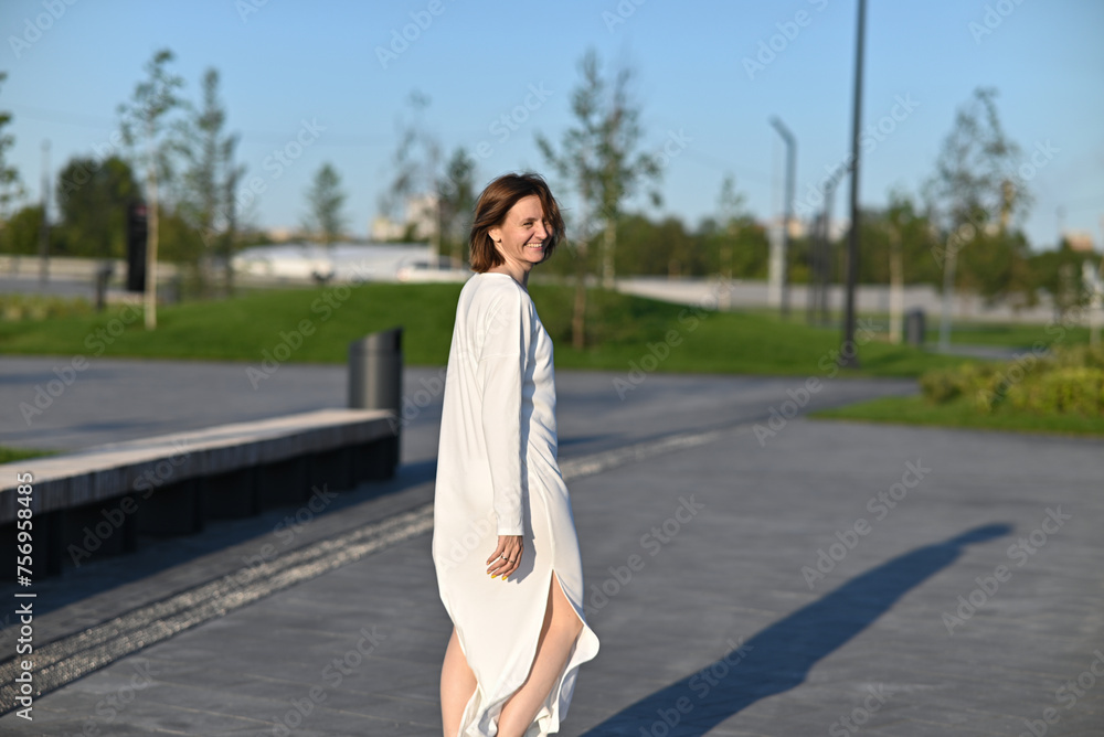 Fototapeta premium Woman crossing the road at a crosswalk