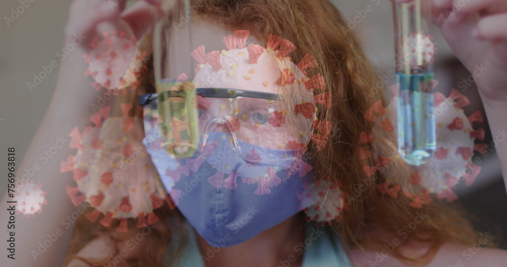 Fototapeta premium Image of covid 19 cells and schoolgirl in science class wearing face mask