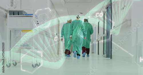 Image of dna strand over diverse surgeons in hospital