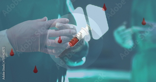 Image of blood drops and syringes over hands of surgeon in hospital