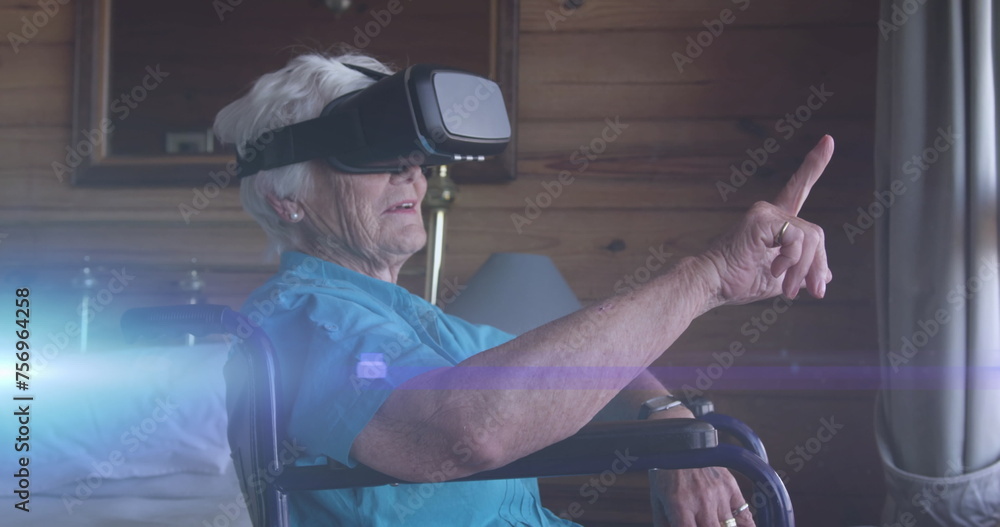 Image of light moving over smiling senior caucasian woman in wheelchair using vr headset