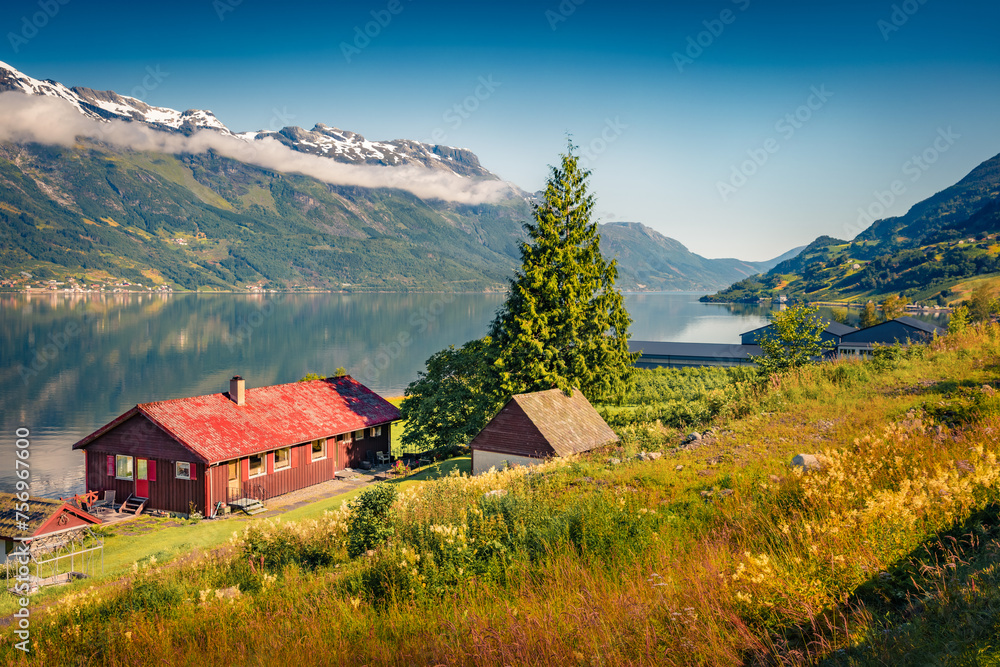 Exciting summer view of Lofthus village in Ullensvang municipality which is located in the Hardanger region of Hordaland county, Norway. Beauty of countryside concept background.