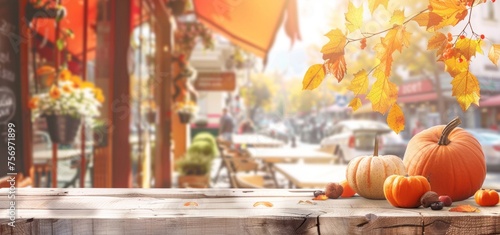 Vibrant autumn arrangement with pumpkins and leaves on a wooden table, with a blurred street background.