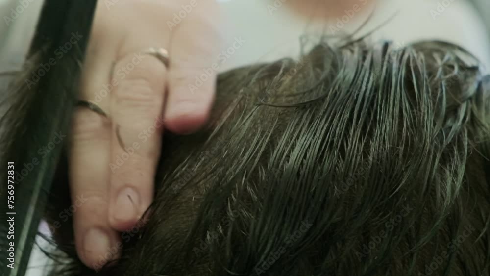 A hairstylist cutting a man's hair A hairstylist cutting a man's hair