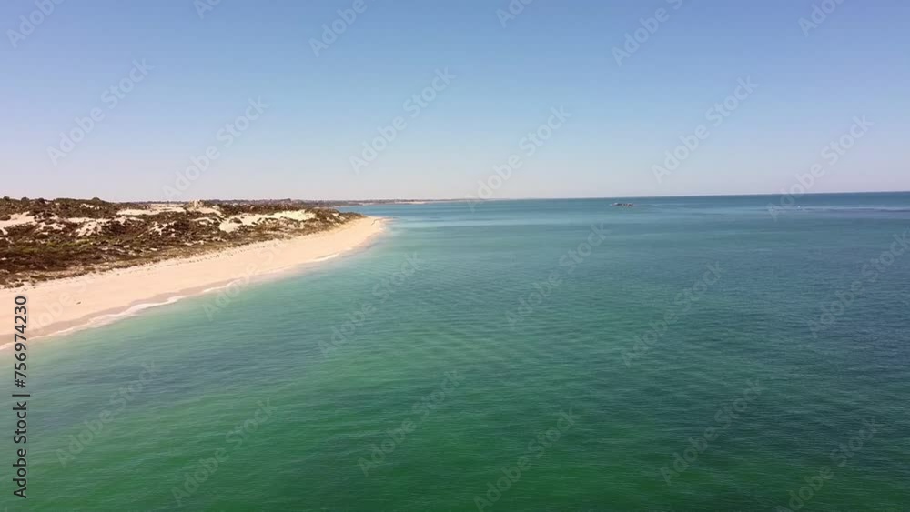 Aerial flyover calm turquoise waters of Mindarie beach, Perth australia