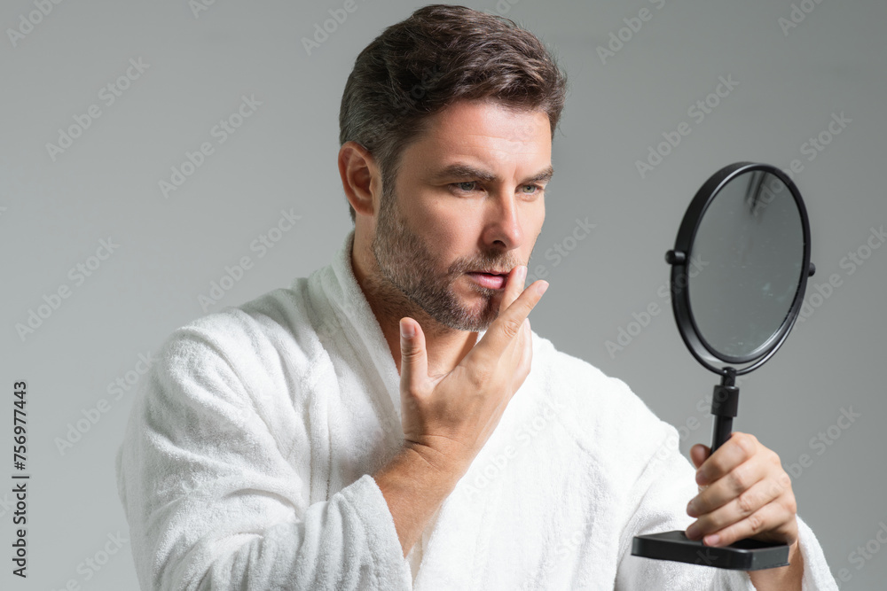 Mens beauty cosmetics, male beauty and skincare. Morning healthcare and hygiene for man. Perfect beauty skin. Handsome millennial man after shower apply nourishing facial cream or mask on skin. Mens beauty cosmetics, male beauty and skincare. Morning healthcare and hygiene for man. Perfect beauty skin. Handsome millennial man after shower apply nourishing facial cream or mask on skin.