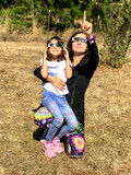 Mother and daughter, family viewing solar eclipse with special glasses in a park
